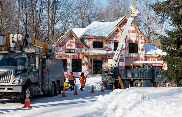 Line workers in action in a new residential neighborhood