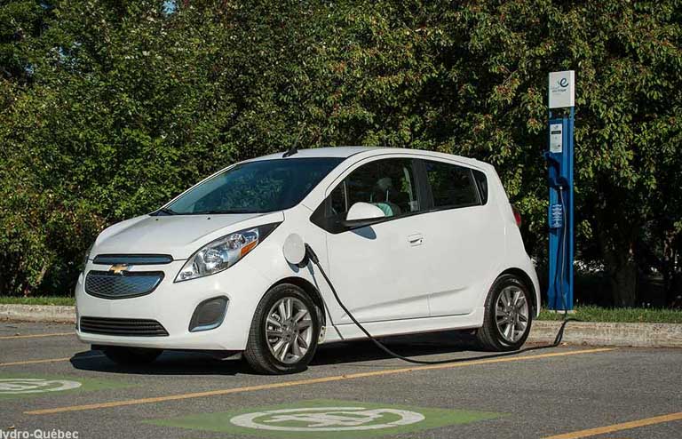 Electric vehicle plugged in to a 240-volt charging station